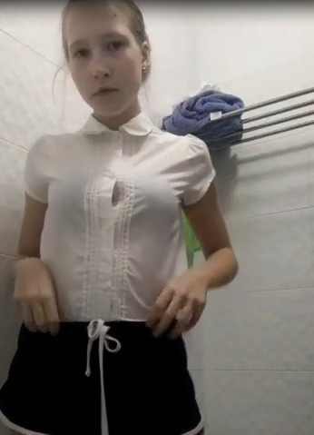 beautiful girl taking off her clothes in the bathroom thumbnail